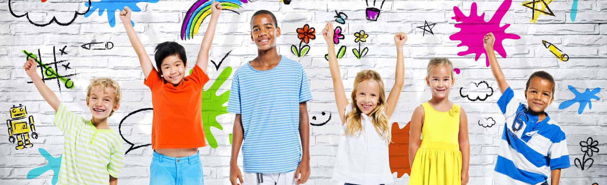 7-minSmiling kids in front of white brick wall